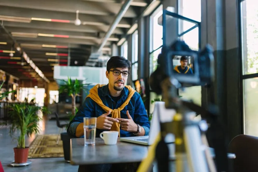 Young male vlogger making content on camera